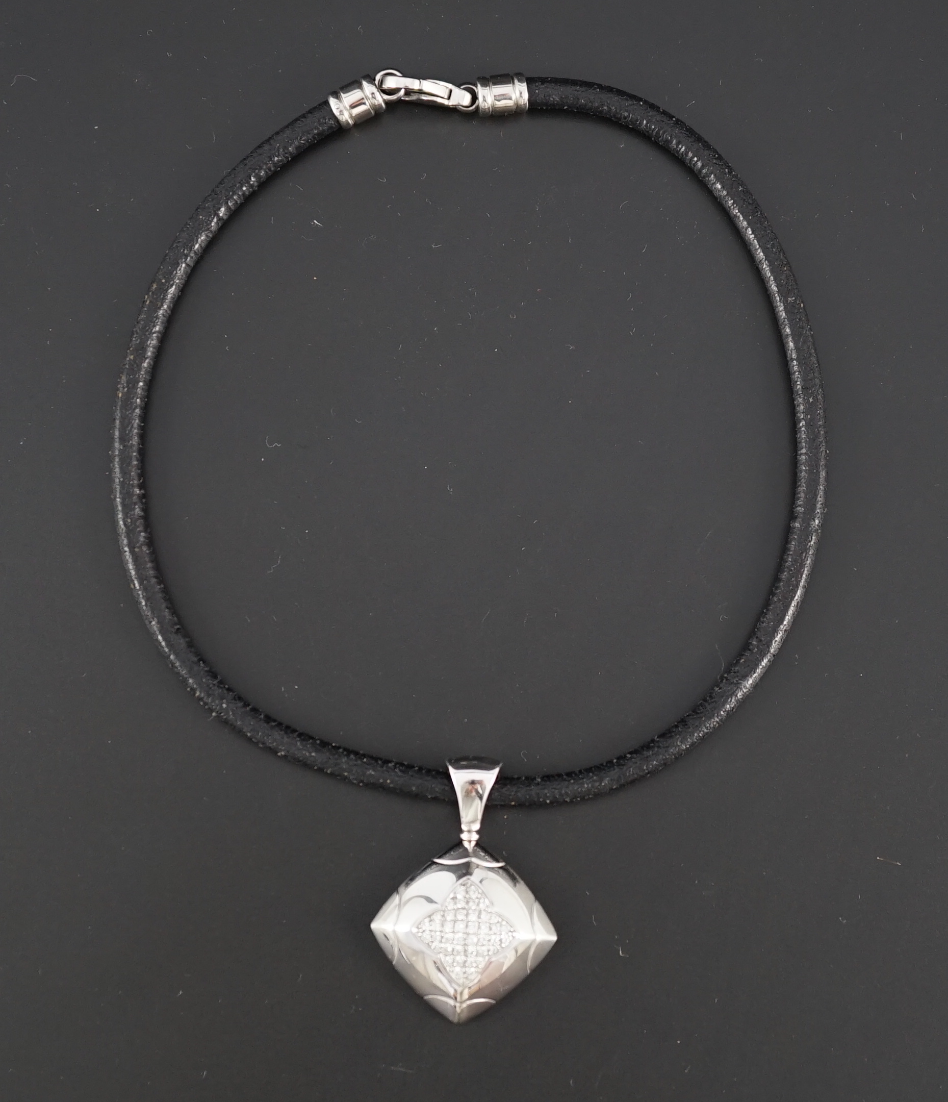 A modern Italian Bulgari 18ct white gold and pave set diamond pendant, on a Bulgari 18ct white gold mounted chord necklet